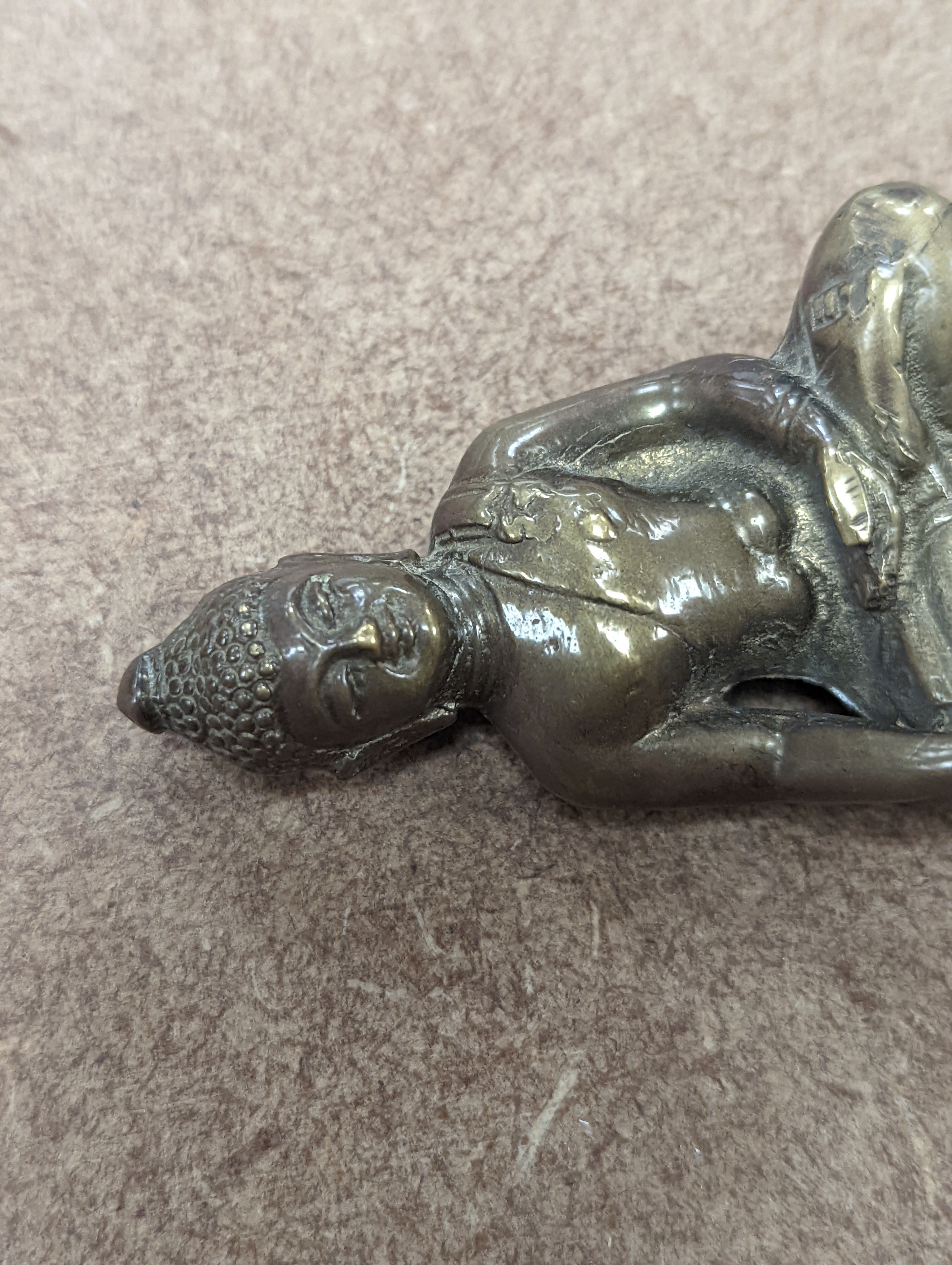 A bronze hand warmer with Xuande mark, 10 cm wide and two Himalayan Buddhist figures, tallest 6.8 cm (3)